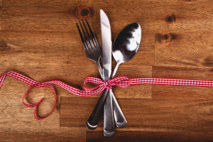 Valentines day set with silverware on wood background